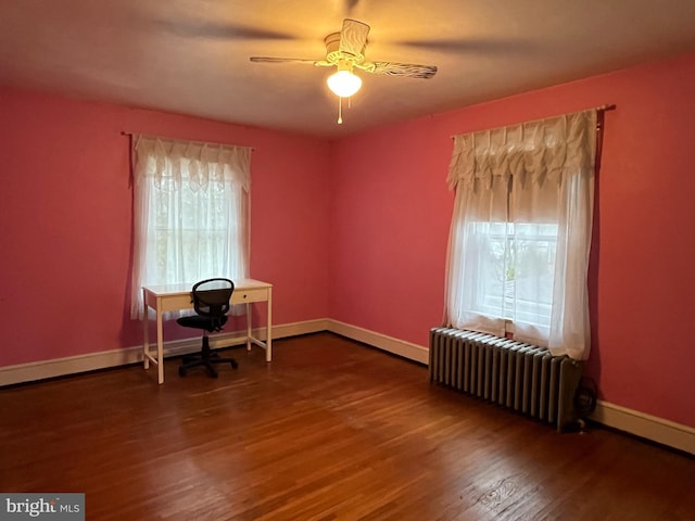 office area featuring radiator, ceiling fan, and hardwood / wood-style flooring