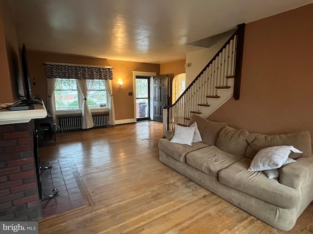 living room with wood-type flooring and radiator heating unit