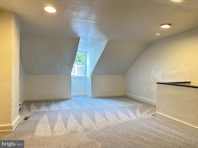 bonus room with carpet floors and vaulted ceiling