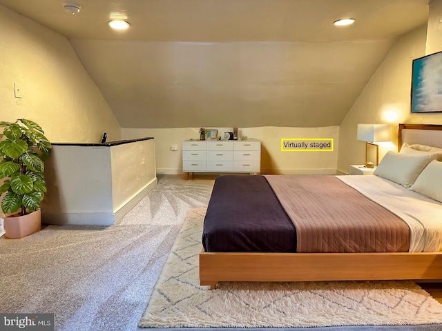 carpeted bedroom featuring lofted ceiling