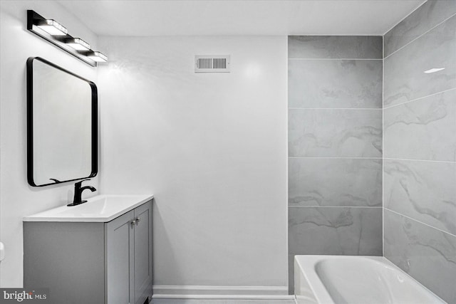 bathroom featuring a washtub and vanity