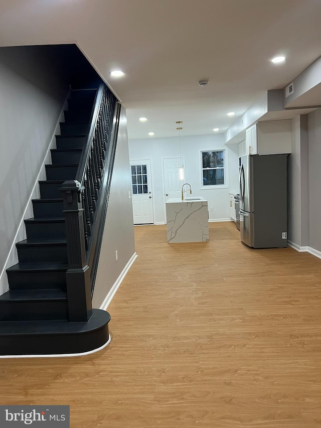 interior space with wood-type flooring and sink