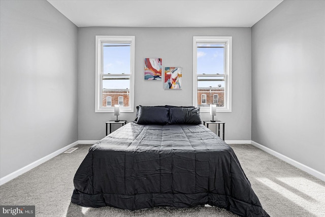 bedroom featuring carpet flooring and multiple windows