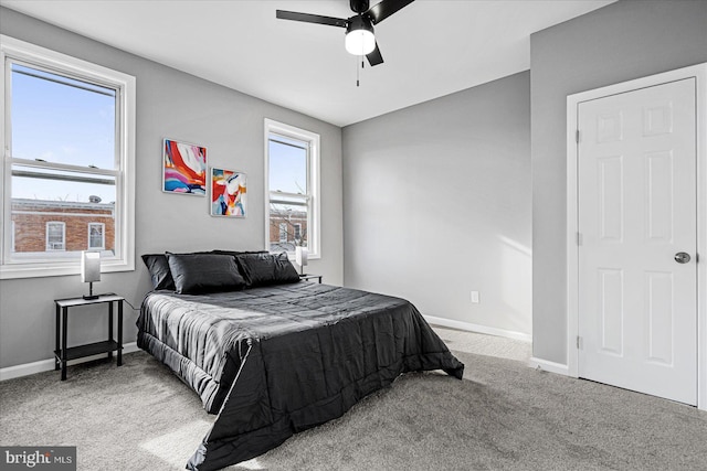 carpeted bedroom with multiple windows and ceiling fan