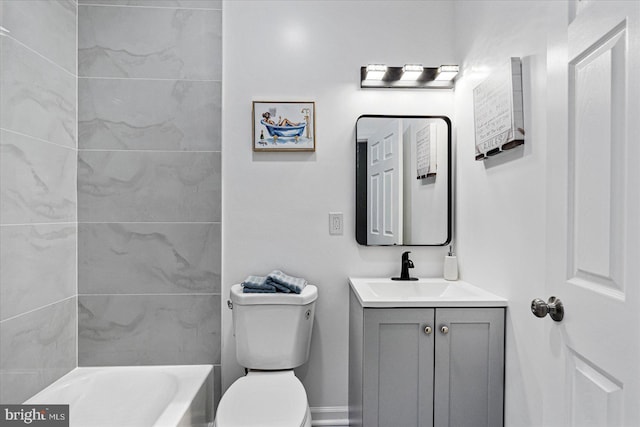 bathroom featuring vanity, a bath, and toilet