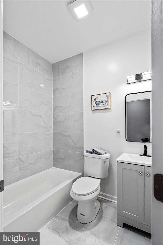 full bathroom featuring vanity, tiled shower / bath combo, and toilet