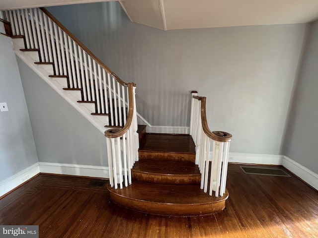 stairway featuring wood-type flooring