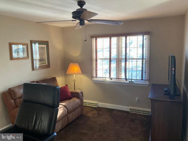 living room featuring dark colored carpet and ceiling fan