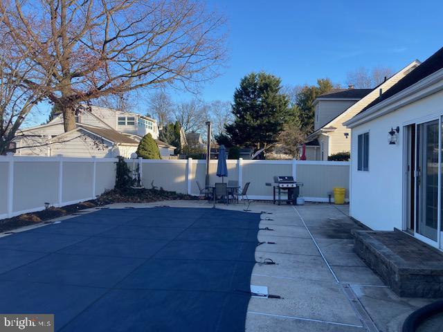 view of swimming pool featuring area for grilling and a patio