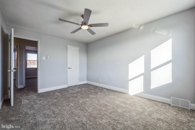 unfurnished bedroom featuring a closet, dark carpet, and ceiling fan