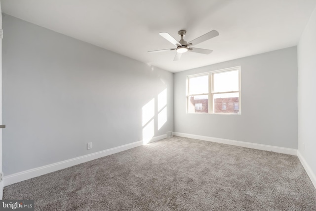 spare room featuring ceiling fan and carpet floors