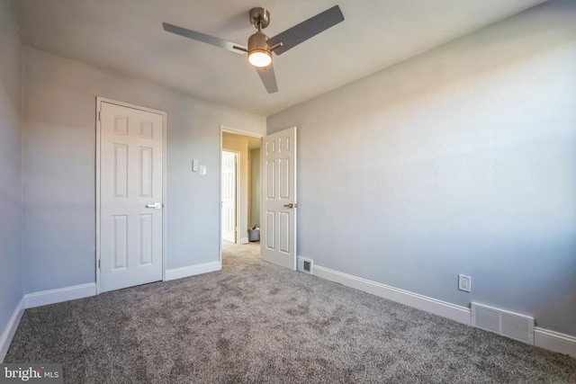 unfurnished bedroom with ceiling fan and carpet