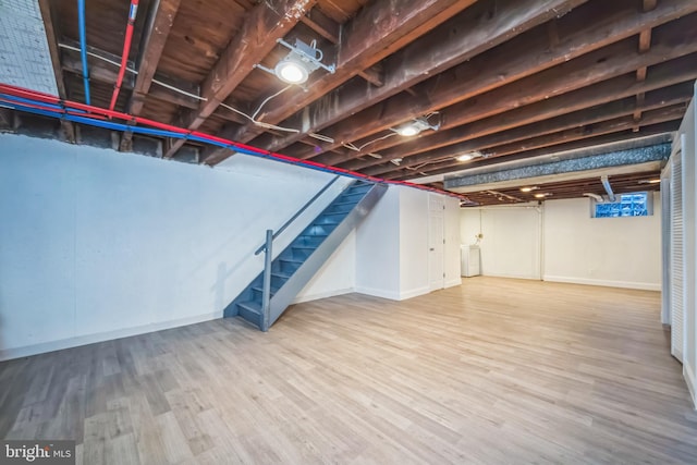 basement with washer / clothes dryer and hardwood / wood-style flooring