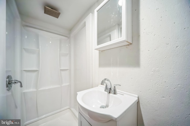 bathroom with vanity and walk in shower