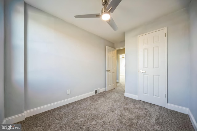 unfurnished bedroom with carpet floors and ceiling fan