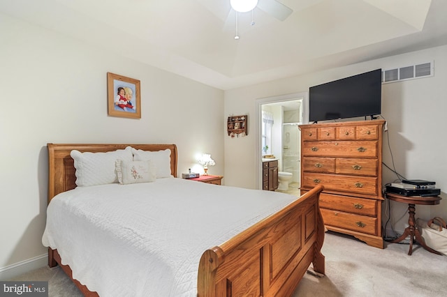 carpeted bedroom featuring ceiling fan and connected bathroom