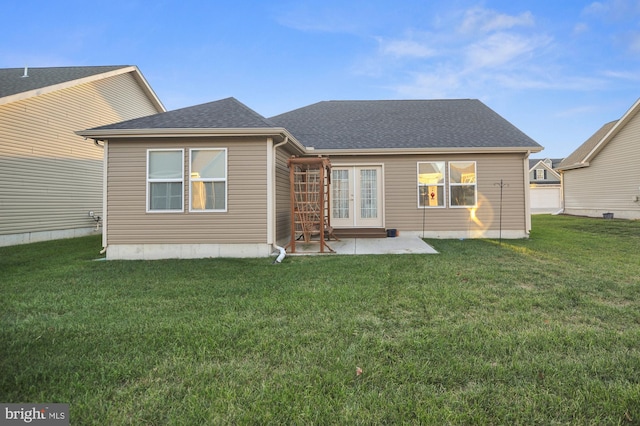 rear view of house with a yard, french doors, and a patio