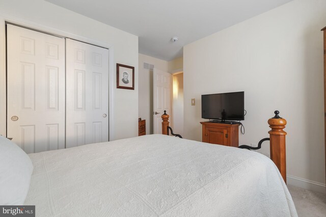 carpeted bedroom featuring a closet