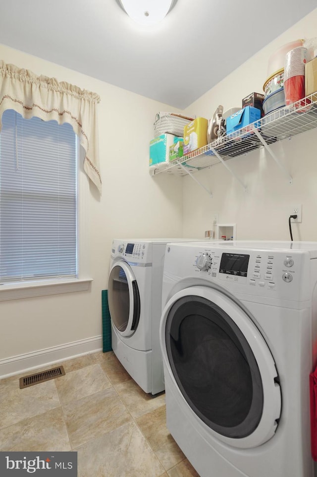 laundry room with washing machine and clothes dryer