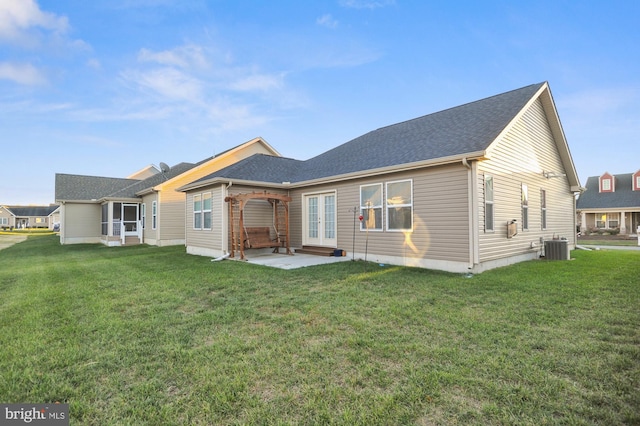 rear view of property with central AC unit, a yard, and a patio