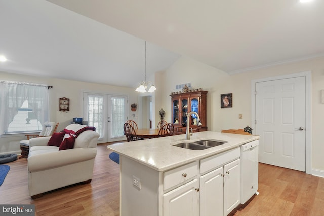 kitchen with pendant lighting, dishwasher, a kitchen island with sink, sink, and white cabinetry