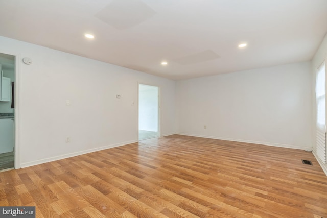 empty room with light hardwood / wood-style flooring