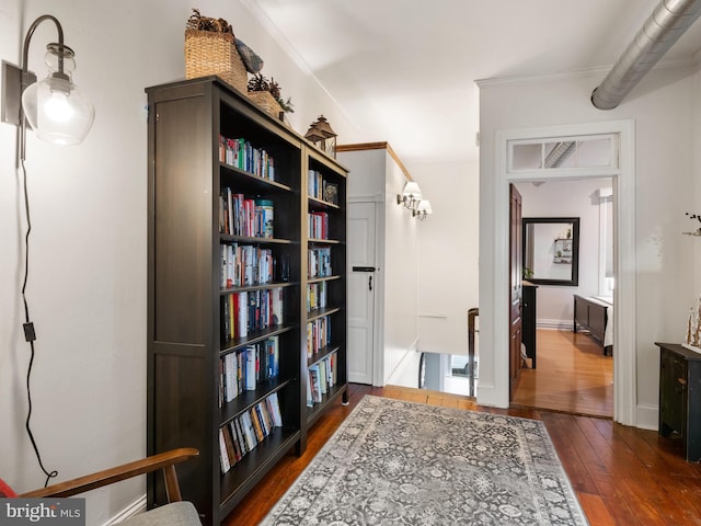 interior space with crown molding and dark hardwood / wood-style flooring