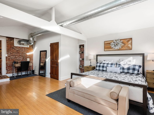 bedroom featuring hardwood / wood-style floors and lofted ceiling