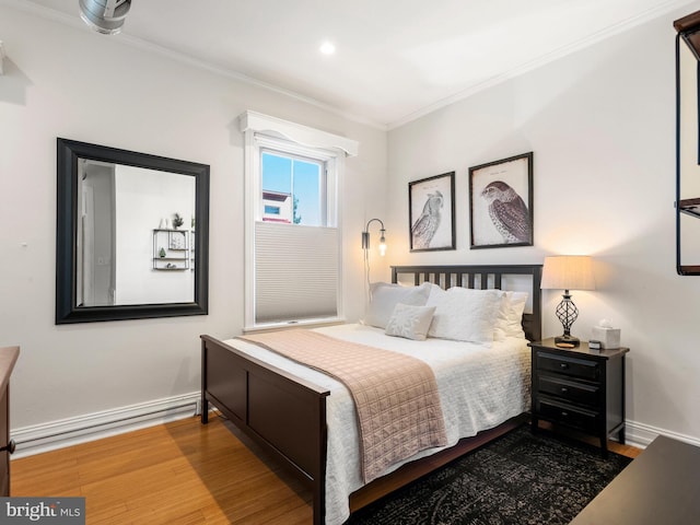 bedroom with crown molding and hardwood / wood-style flooring