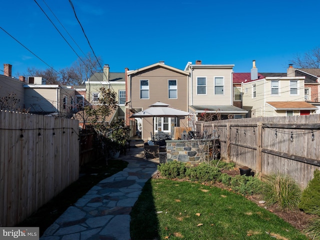 rear view of property with a yard