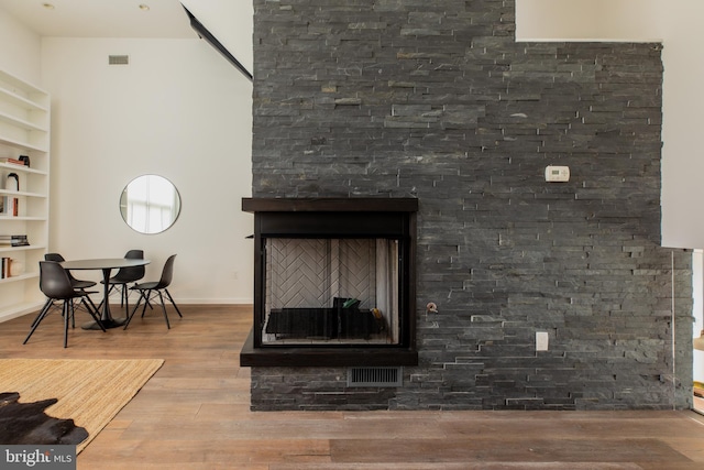 living room featuring hardwood / wood-style floors and built in features