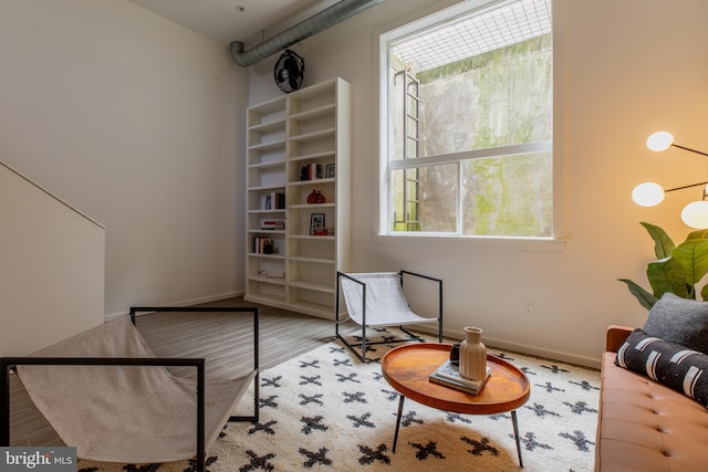 living area with hardwood / wood-style floors