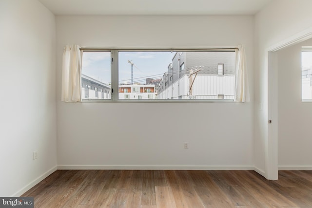 unfurnished room with wood-type flooring