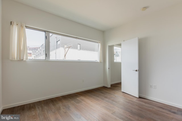 spare room featuring hardwood / wood-style floors