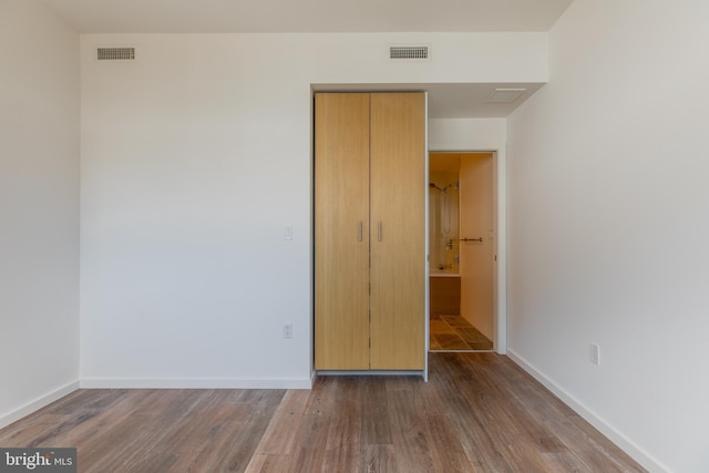 unfurnished bedroom featuring dark hardwood / wood-style flooring