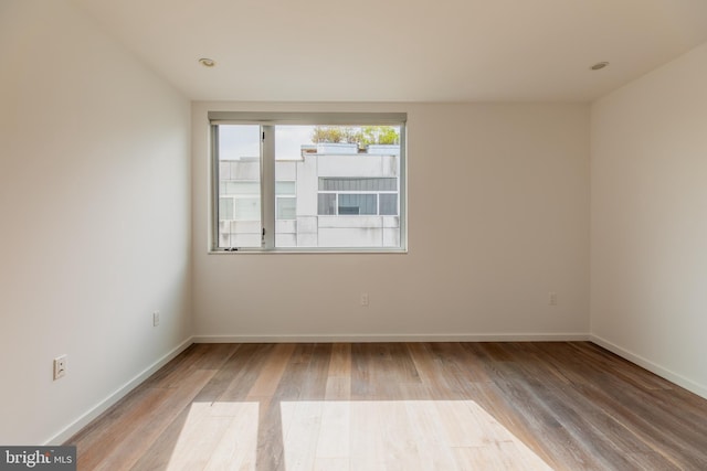 unfurnished room with hardwood / wood-style floors