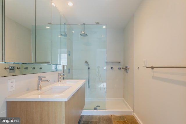 bathroom featuring a tile shower and vanity