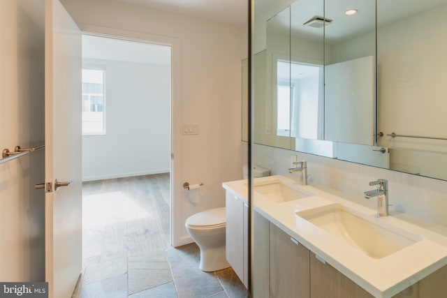 bathroom with toilet and vanity