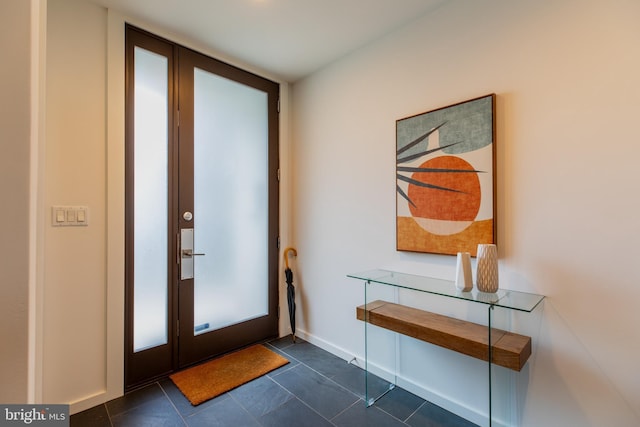 doorway to outside featuring dark tile patterned floors