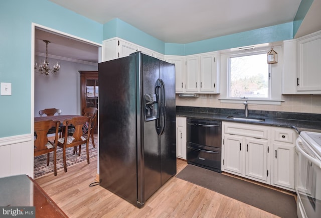 kitchen featuring light wood-type flooring, sink, white cabinets, and black appliances