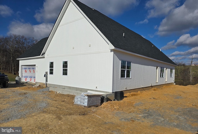 view of side of home featuring a garage