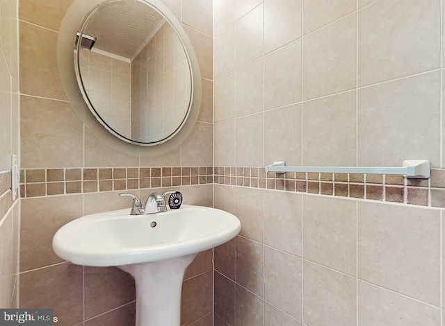 bathroom with tile walls