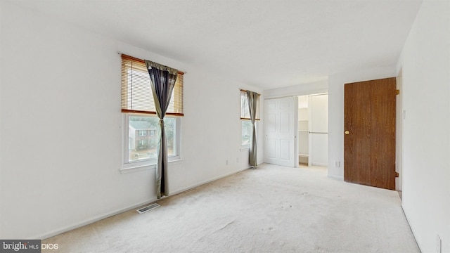 empty room featuring light colored carpet