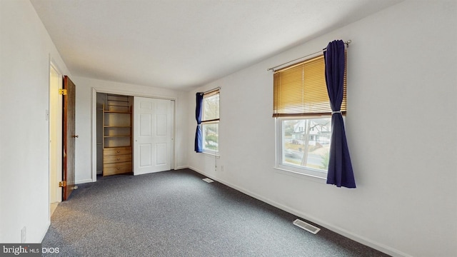 unfurnished bedroom with a closet and carpet