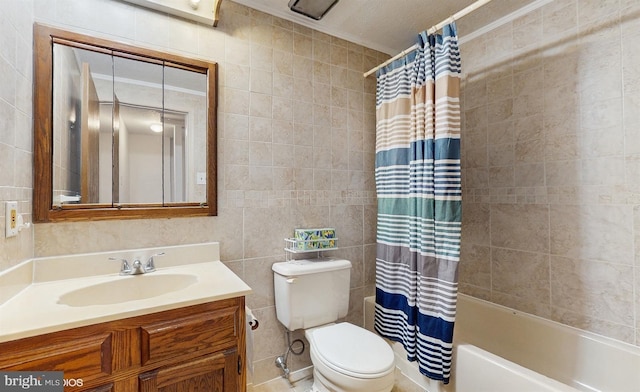 full bathroom featuring vanity, toilet, tile walls, and shower / tub combo