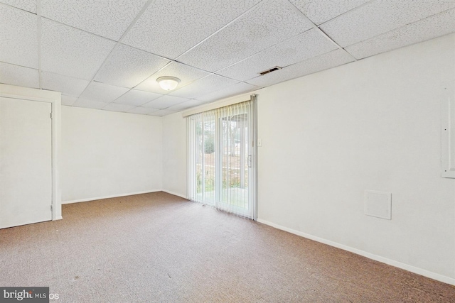 unfurnished room with carpet and a drop ceiling