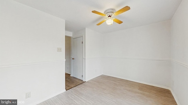 empty room featuring ceiling fan and hardwood / wood-style flooring