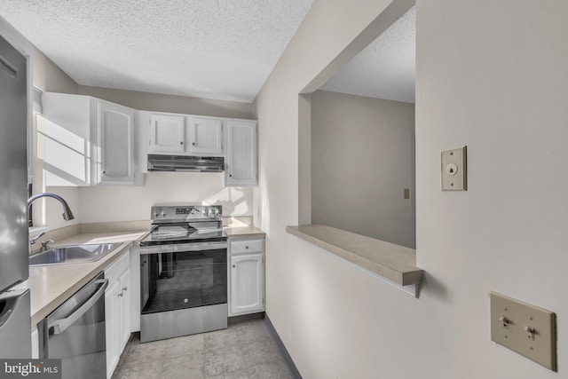 kitchen featuring sink, white cabinets, stainless steel appliances, and a textured ceiling