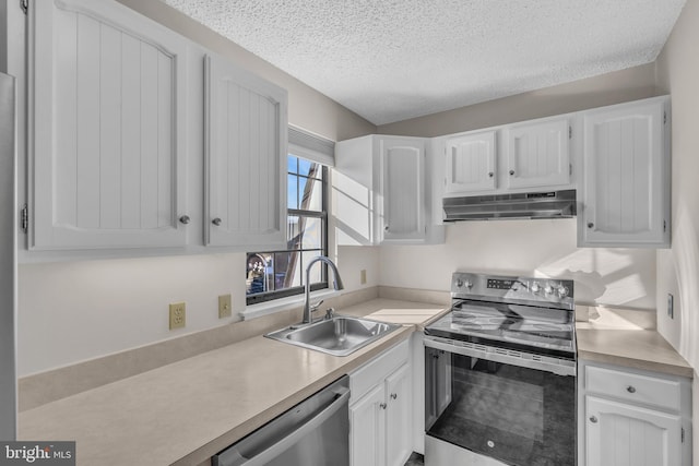 kitchen featuring sink, white cabinets, stainless steel appliances, and a textured ceiling