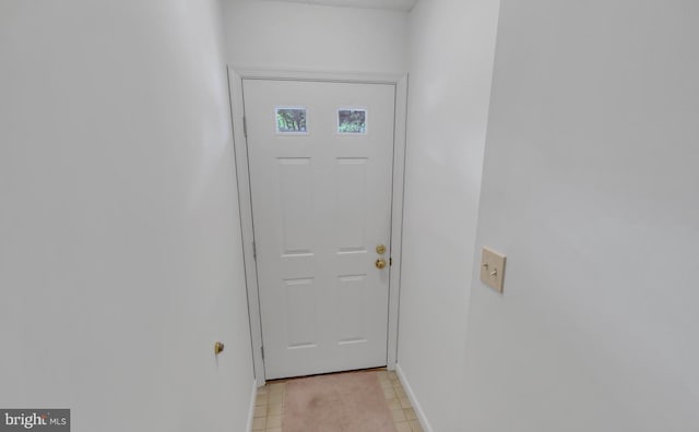 doorway featuring light tile patterned flooring